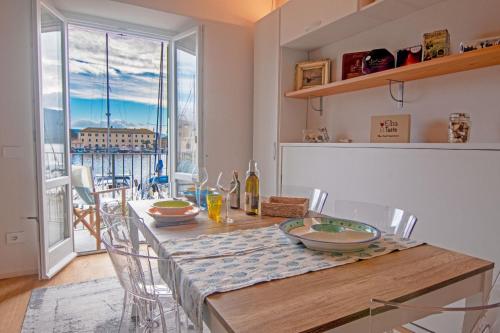 a kitchen with a table with chairs and a dining room at La Calata - Monolocale in Portoferraio