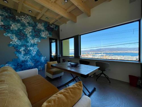 a living room with a couch and a table at Hakodate As time flies -Sauna&Villa- 函館 時のたつままに in Hakodate