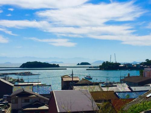 a view of a large body of water with boats at 城跡石垣上の絶景古民家宿 鞆城茶屋庵 in Tomo