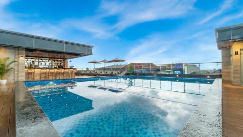 a swimming pool on the roof of a building at City of Aventus Hotel - Denpasar in Denpasar