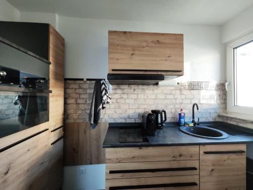 a kitchen with wooden cabinets and a sink at Silverstar in Sindelfingen