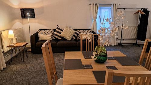 a living room with a table and a couch at The Old Vicarage in Flore