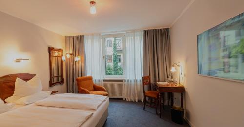 Postel nebo postele na pokoji v ubytování Hotel Olympic