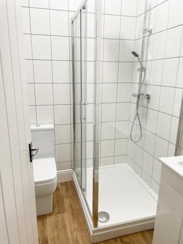 a bathroom with a shower and a toilet at The Old Vicarage in Flore