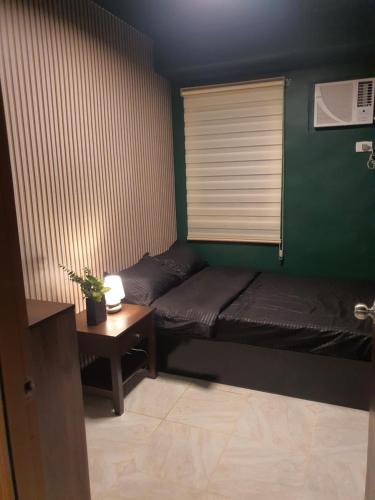 マンダウエ・シティにある2BR condo at banilad cebu 650のベッドルーム1室(ベッド1台、窓のあるテーブル付)