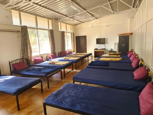 a room with a row of tables and chairs at PANSHET VALLEY RESORT- MTDC & Agro Tourism in Pune