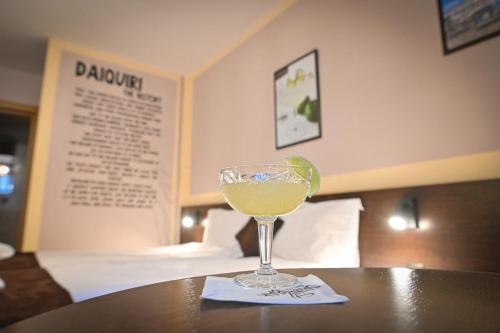 a drink in a glass on a table in a hotel room at Hotel Ida in Bansko