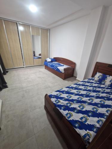 a bedroom with two beds in a room at Appartement côté mer in Reghaïa