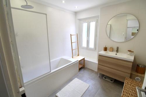 une salle de bain avec une baignoire, un lavabo et un miroir dans l'établissement Luberon - Air-conditioned apartment, à Le Puy-Sainte-Réparade