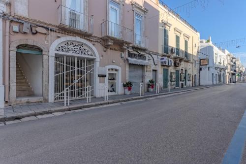 an empty street in a city with buildings at Palazzo Extravacanza in Polignano a Mare