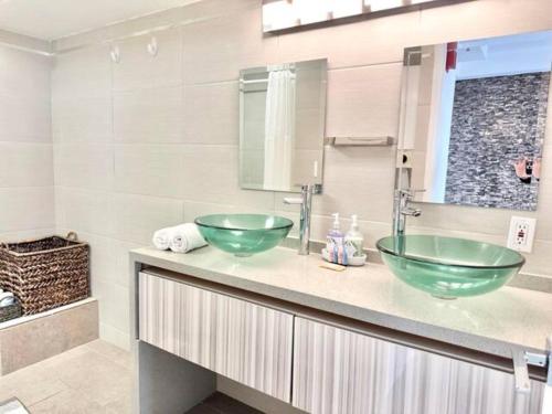 a bathroom with two green bowls on a counter at Waikiki Ocean View Penthouse 2/2 bdr/bath in Honolulu