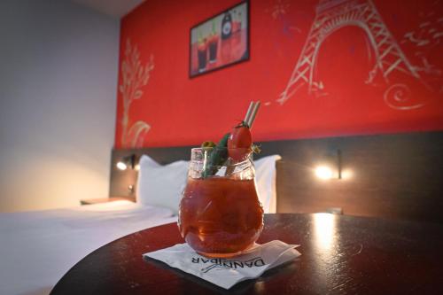 a drink sitting on a table in a hotel room at Hotel Ida in Bansko