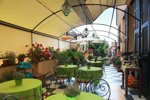 a patio area with tables, chairs and umbrellas at Locanda Il Maestrale in Monterosso al Mare