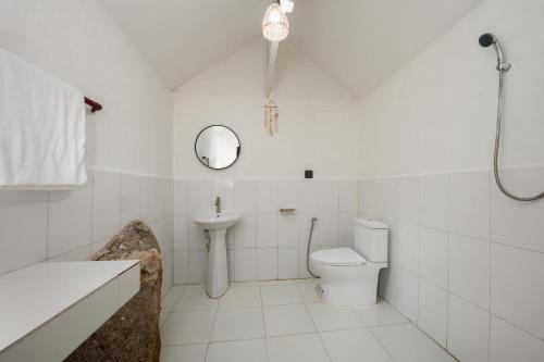 bagno con servizi igienici, lavandino e specchio di The Source Yoga and Nature Sanctuary Koh Phangan a Ko Phangan