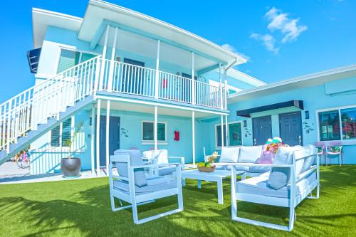 a patio with two chairs and a couch at The Pearl Cabana Club in St Pete Beach