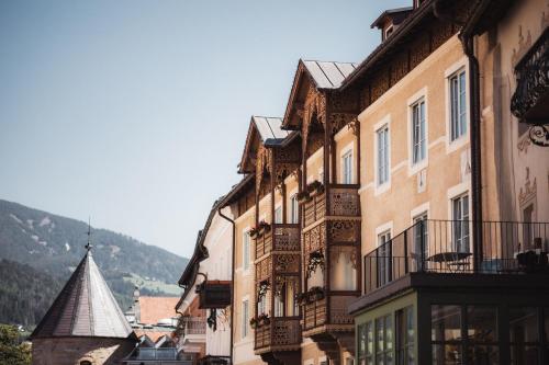 a group of buildings with balconies on a street at Avia Living Maria in Brunico