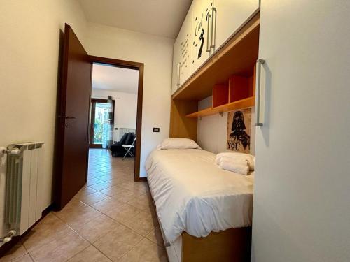 a bedroom with a bed and a door to a room at Kibilù - Residence with Pool, near Lake Maggiore in  Monvalle 