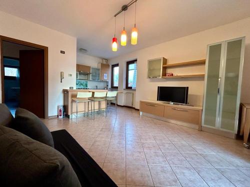 a living room with a couch and a kitchen at Kibilù - Residence with Pool, near Lake Maggiore in  Monvalle 