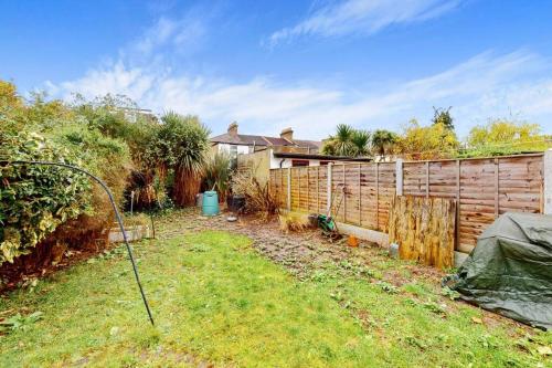 a backyard with a wooden fence at Charming 1BD flat with a private garden in Leyton in London