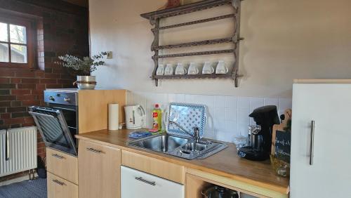 a kitchen with a sink and a counter top at 3 Zi. 30 Min. von Hamburg, Landhaus Wohnung in Klein Offenseth-Sparrieshoop