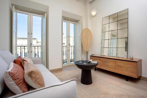 a living room with a couch and a table at Genteel Home San Francisco Suites in Seville