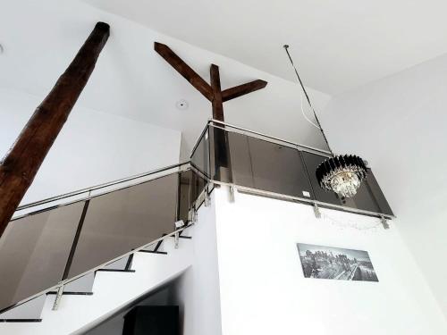 a staircase in a house with a cross on the wall at Casuta din drumul muntelui in Drăguş