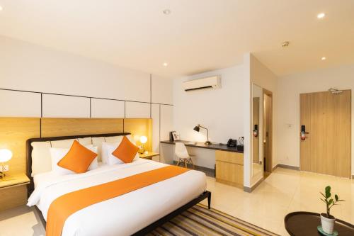 a bedroom with a large bed and a kitchen at CDX RESIDENCE in Phnom Penh