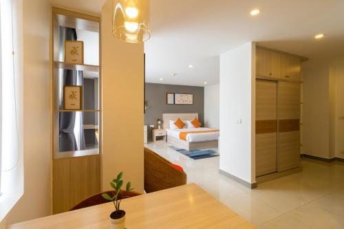 a bedroom with a bed and a table in a room at CDX RESIDENCE in Phnom Penh