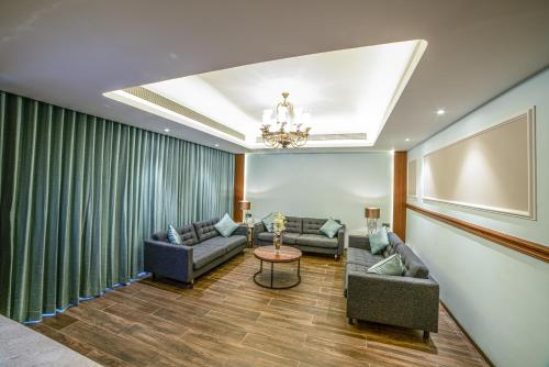 a living room with two couches and a table at Gift City Club, a member of Radisson Individuals in Gandhinagar