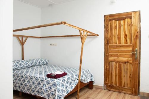 a bedroom with a bed and a wooden door at Maison entière à vous. 