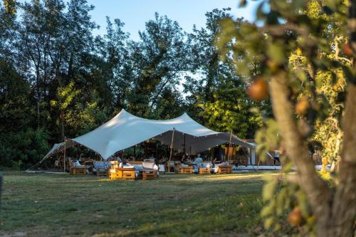 a large white tent in a field with tables at Mas de Capelou in Avignon