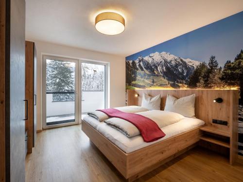 a bedroom with a bed with a mountain mural on the wall at Ferienwohnung Klocker in Fügenberg