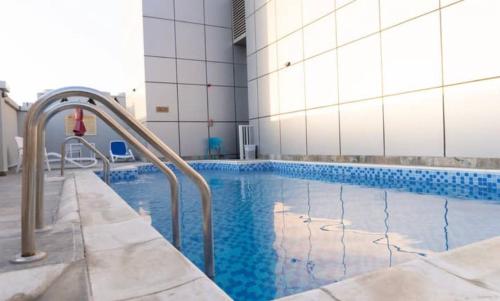 a swimming pool in a building with aicrobialicrobialicrobialicrobial at Global golf residency 2, sports city in Dubai