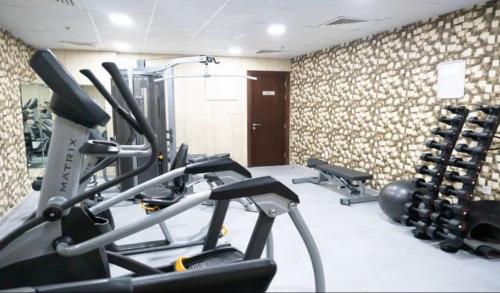 a gym with several tread machines in a room at Global golf residency 2, sports city in Dubai
