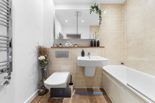 a bathroom with a sink and a toilet and a tub at Two Bedroom Flat By Zen Abodes Short Lets & Serviced Accommodation with Free Wifi & TV Close to Old St in London