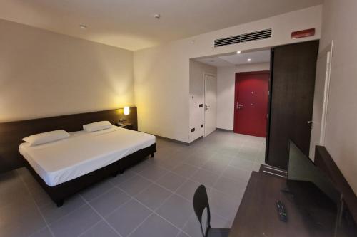 a bedroom with a bed and a red door at Inn Naples Airport in Gricignano dʼAversa