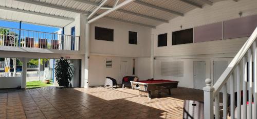 a house with a pool table in a courtyard at Pit Stop Hostel in Aguada