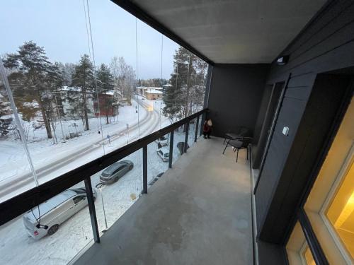 a balcony of a building with a view of a street at Kolme Kiveä in Rovaniemi