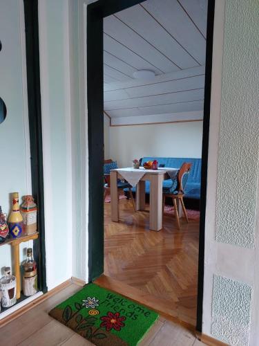 a dining room with a table and a mirror at Аpartman ELENA in Rakovac