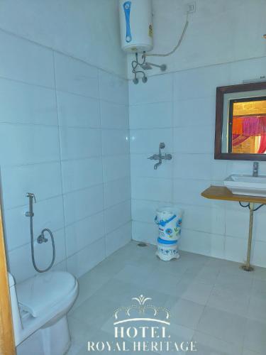 a bathroom with a toilet and a sink at Hotel Royal Heritage in Jaisalmer