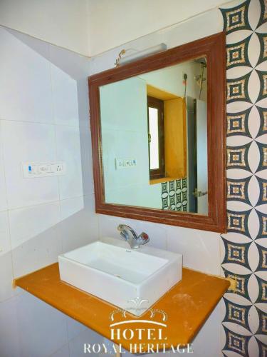 a bathroom with a sink and a mirror at Hotel Royal Heritage in Jaisalmer