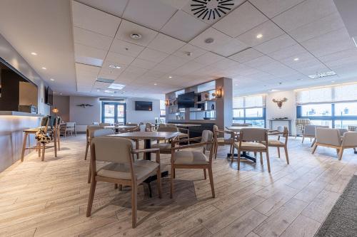 a restaurant with tables and chairs in a room at Apartamentos Caribou in Pas de la Casa