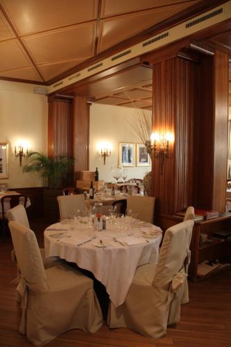 a dining room with a white table and chairs at Enjoy 1313AG Hotel Touring in Chiasso