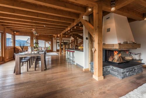 a kitchen and dining room with a fireplace in a house at Chalet Omaroo Morzine - by EMERALD STAY in Morzine