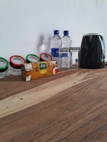 a wooden counter with bottles of water and a toaster at RKO Villa27 - Unawatuna in Habaraduwa