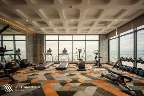 a fitness room with a gym with a view at Tony Apartment - Apec Mandala Phú Yên in Tuy Hoa