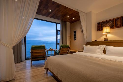 a bedroom with a large bed and a large window at Dali Beauty Seaview B&B in Dali