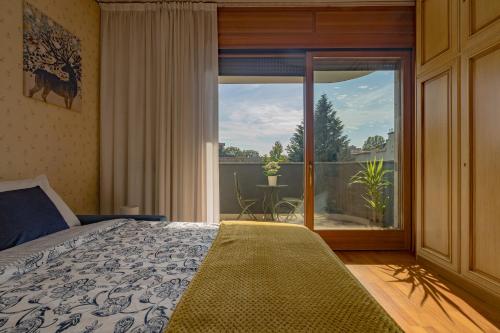 a bedroom with a bed and a large window at Porta Romana Suite di Charme in Milan