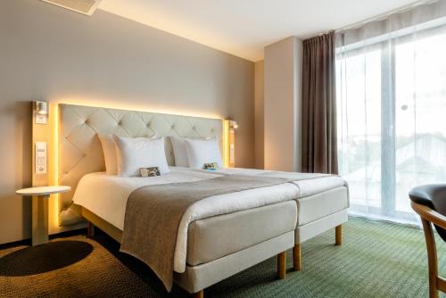 Postel nebo postele na pokoji v ubytování Metropol Spa Hotel