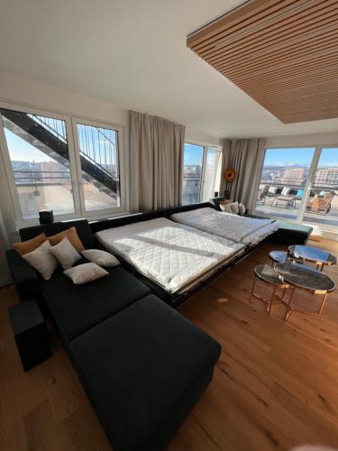 a large bedroom with a large bed and a couch at Albelli Luxury Skyview in Košice